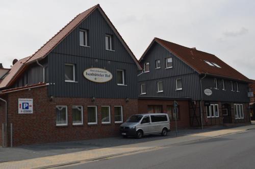 a white van parked in front of a building at Hotel Isenbütteler Hof in Isenbüttel