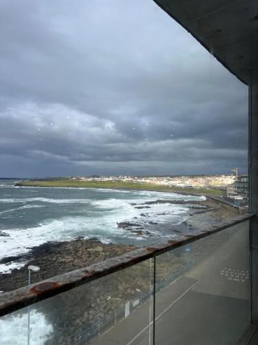 a view of the ocean from the balcony of a building at Seaview Hideway - Abnb in Portstewart