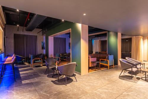 a group of chairs and tables in a room at Park Inn by Radisson Vellore in Vellore