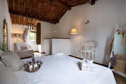 a bedroom with a white bed and a swing at Gipsy Maisonette in Lucca