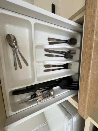 a drawer filled with utensils in a kitchen at Bella Apartments Brno in Brno