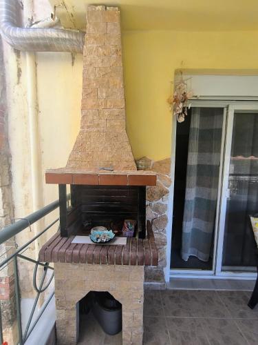 an outdoor brick oven sitting on a balcony at Blue lagoon in Skála Foúrkas
