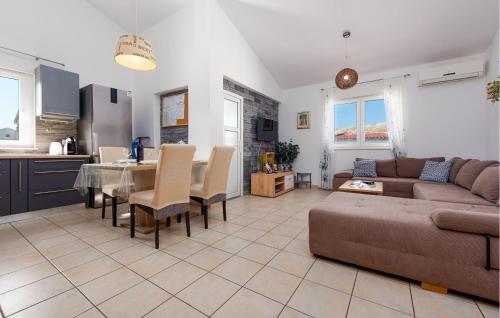 a living room with a couch and a table and a kitchen at 1 Bedroom Gorgeous Apartment In Pag in Pag
