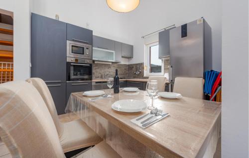 a kitchen with a wooden table with wine glasses at 1 Bedroom Gorgeous Apartment In Pag in Pag