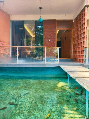 a house with a pool of water in the floor at Udaya Resort in Palakkad