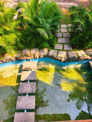 a garden with a pool of water and plants at Udaya Resort in Palakkad