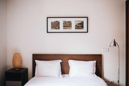 a bedroom with a bed with white pillows at Premium Apartment with Private Terrace & Garage in Porto