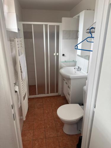 a small bathroom with a toilet and a sink at Retro domeček Dolany u kruháče in Dolany
