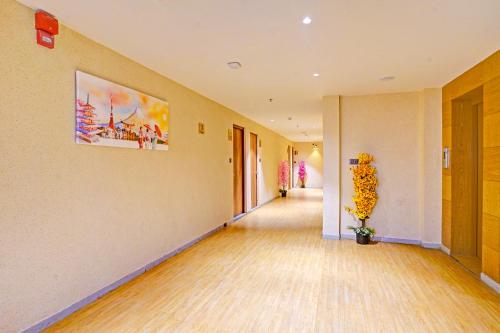 an empty hallway with a painting on the wall at FabHotel Siddharth Inn - Nr Siddharth Bunglows in Gandhinagar