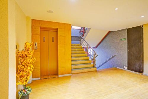 a hallway with a staircase in a building at FabHotel Siddharth Inn - Nr Siddharth Bunglows in Gandhinagar