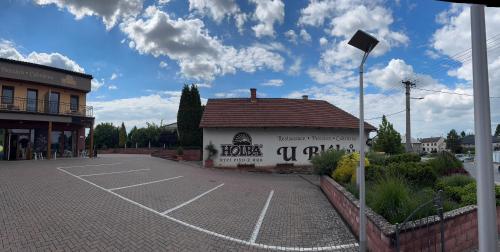 a parking lot in front of a building at Retro domeček Dolany u kruháče in Dolany