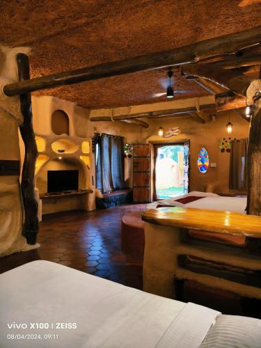 a large room with a bed and a fireplace at Udaya Resort in Palakkad