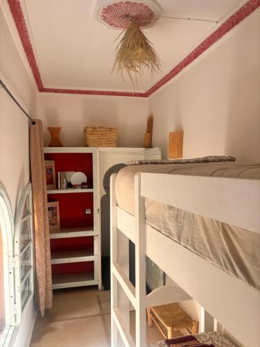 a bedroom with two bunk beds and a ceiling at Riad Sanwa in Marrakech