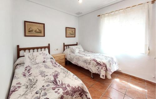 a bedroom with two beds and a window at Awesome Home In Bétera in Bétera