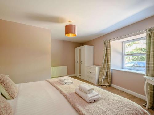 a bedroom with a bed with towels on it at 2 Bed in Sanquhar 89403 in Sanquhar