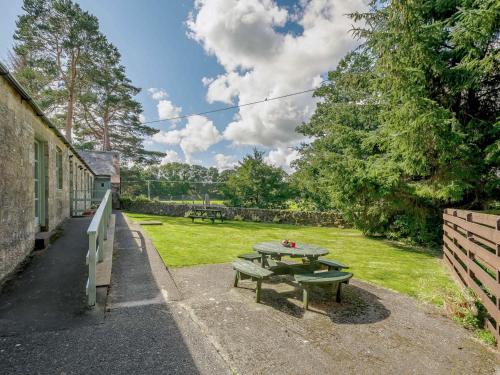a picnic table and bench in a yard at 2 Bed in Sanquhar 89403 in Sanquhar