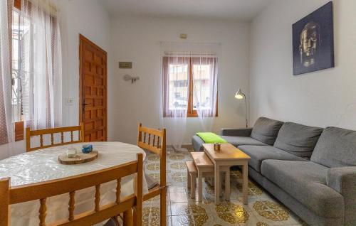 a living room with a couch and a table at Awesome Home In Torrevieja With Wifi in Torrevieja