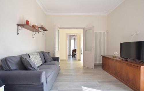 a living room with a couch and a flat screen tv at Beautiful Apartment In Piano Di Mommio in Piano di Mommio