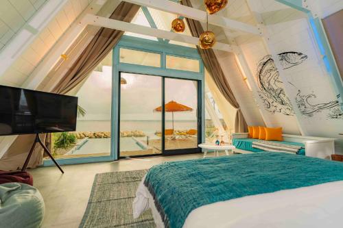 a bedroom with a bed and a view of the ocean at Oaga Art Resort Maldives - Greatest All Inclusive Plan with Free Speedboat Round-trip in North Male Atoll