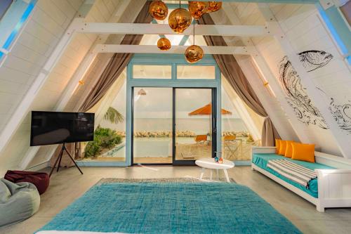 a living room with a view of the ocean at Oaga Art Resort Maldives - Greatest All Inclusive Plan with Free Speedboat Round-trip in North Male Atoll