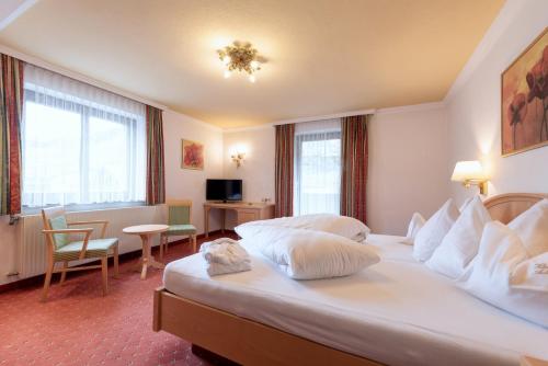 Ένα ή περισσότερα κρεβάτια σε δωμάτιο στο Heart Hotel Arlberg