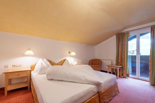 Ένα ή περισσότερα κρεβάτια σε δωμάτιο στο Heart Hotel Arlberg
