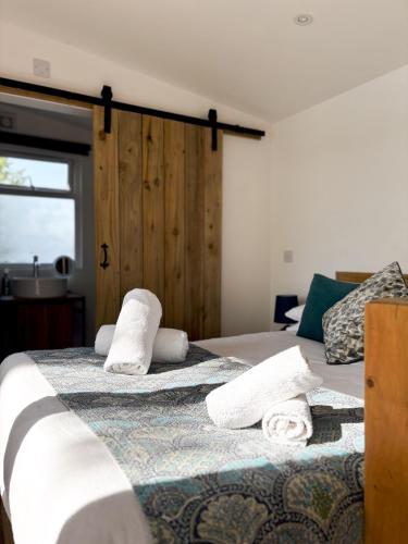 a bedroom with two beds with towels on them at Lakeside Lodge- 'Swallow' in Bishampton