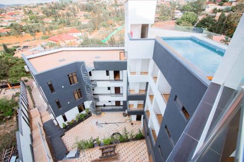 an aerial view of a building with a swimming pool at Cascadia Hotel Apartments by GF Greenland in Kigali