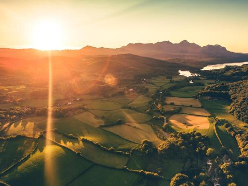 an aerial view of a golf course at sunset at 1 Bed in Coniston LCC37 in High Nibthwaite