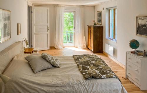 a large bed in a room with a large window at Pet Friendly Home In Löderup With Wifi in Löderup
