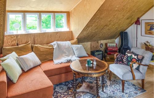a living room with a couch and a table at Pet Friendly Home In Löderup With Wifi in Löderup