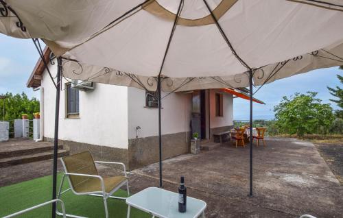 a large white tent with chairs and a table at Beautiful Home In Bronte With Wifi in Maletto