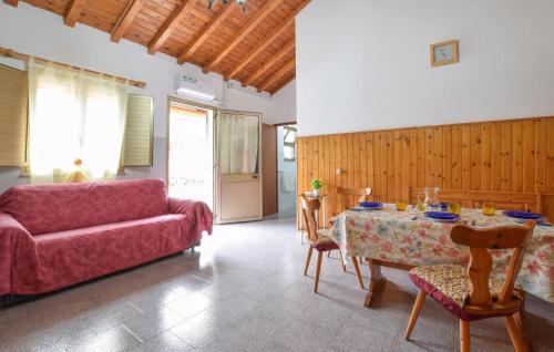 a living room with a red couch and a table at Beautiful Home In Bronte With Wifi in Maletto
