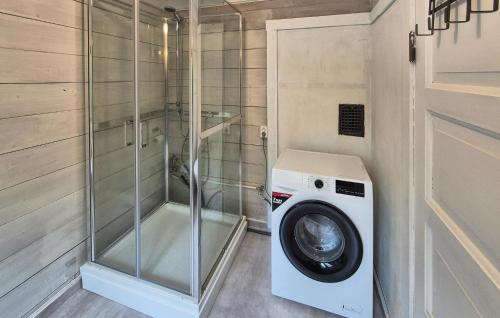 a washing machine in a bathroom with a glass shower at Nice Home In Aksdal With House Sea View in Aksdal