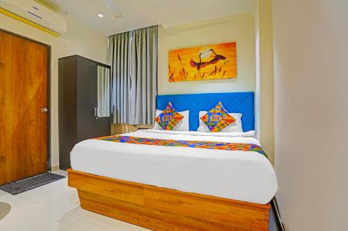 a bedroom with a large bed in a room at FabHotel Siddharth Inn - Nr Siddharth Bunglows in Gandhinagar