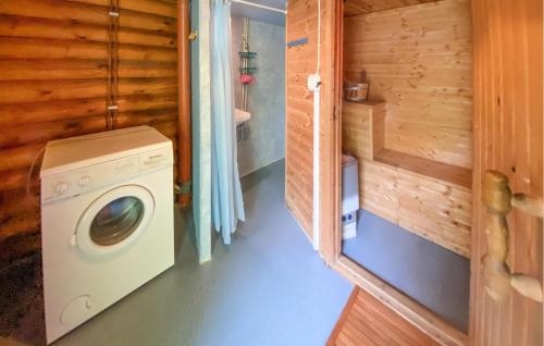 a washer and dryer in a room with a bathroom at Stunning Home In Västervik With Sauna in Västervik
