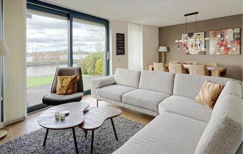 a living room with a couch and a table and chairs at 3 Bedroom Cozy Home In Lemmer in Lemmer