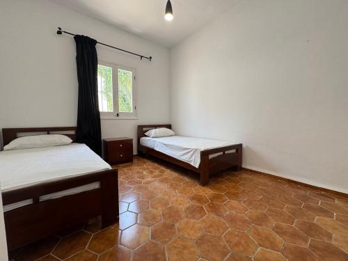 a room with two beds and a window at C2 Résidence CHATT in Tetouan