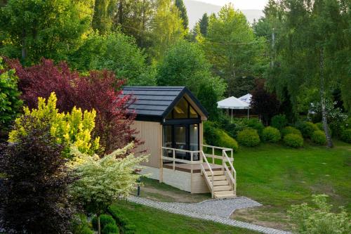 a small shed with a staircase in a garden at Villa Biesisko Przysłup Cisna in Cisna