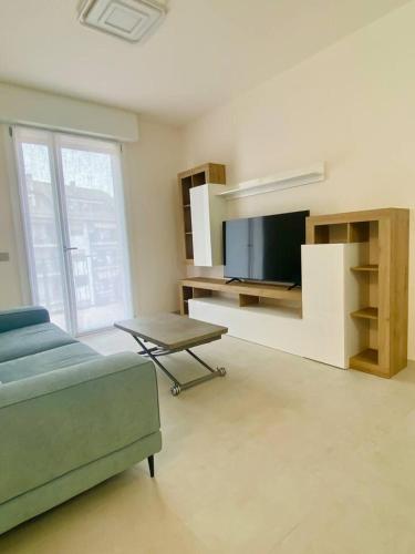 a living room with a couch and a tv at Luxury Apartment with a View of Conegliano Castle in Conegliano