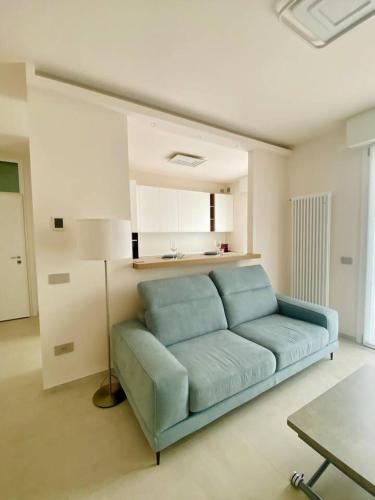 a living room with a blue couch in a room at Luxury Apartment with a View of Conegliano Castle in Conegliano