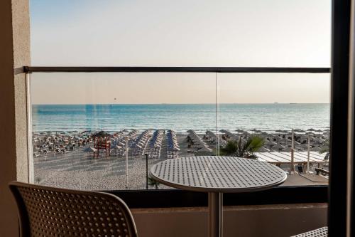 a view of a beach with a table and chairs at Aks Hotel in Durrës