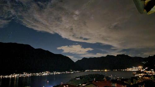 a view of a city and a body of water at night at Vista Lago Como in Ossuccio