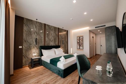 a hotel room with a bed and a table at Aks Hotel in Durrës
