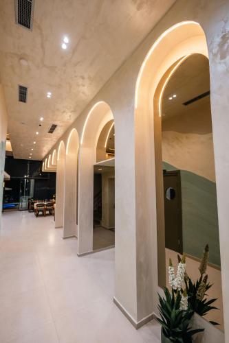 a hallway of a building with arches on the walls at Aks Hotel in Durrës