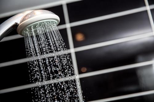 a shower with water pouring out of it at Holiday Inn Express London Stratford by IHG in London