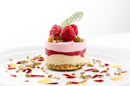 a piece of cake with berries on a plate at Albergo La Rocca in Brisighella