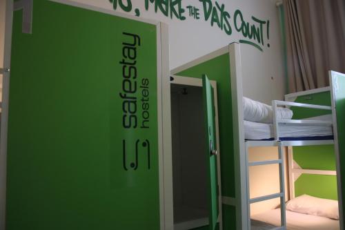 a room with a green door and a bunk bed at Safestay Edinburgh Cowgate in Edinburgh