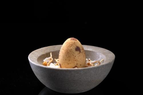 a small white bowl with a pear in it at Elysium Resort & Spa in Faliraki