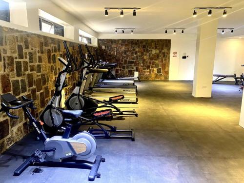 a row of exercise bikes lined up in a gym at Cascadia Hotel Apartments by GF Greenland in Kigali